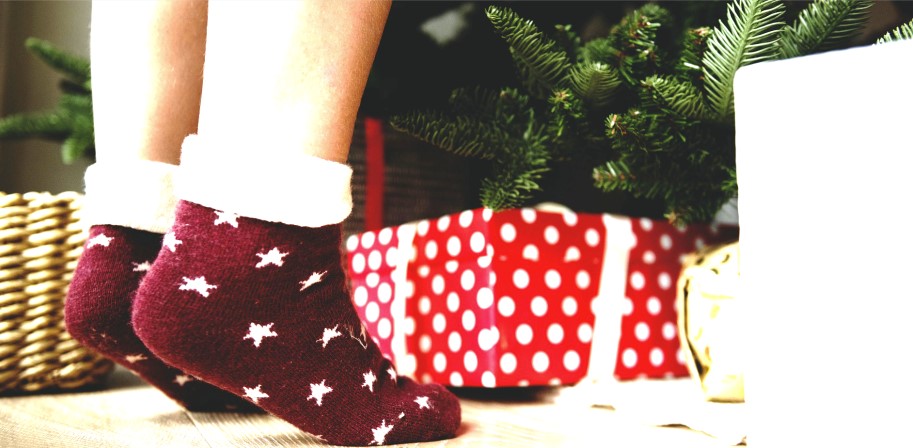feet on tip toes in front of Christmas tree
