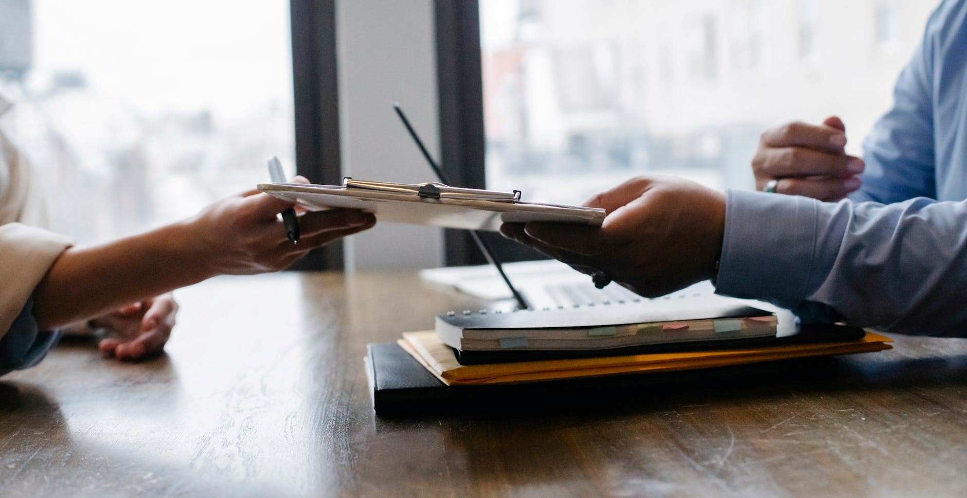 two people holding on to a clipboard