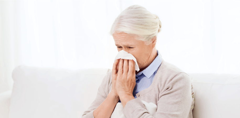 Elderly woman covering nose