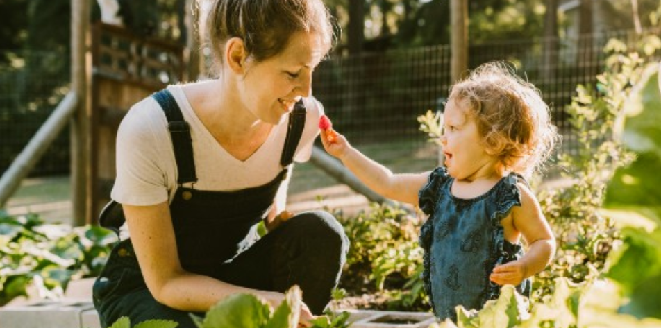 woman planting in garden with child allergy free